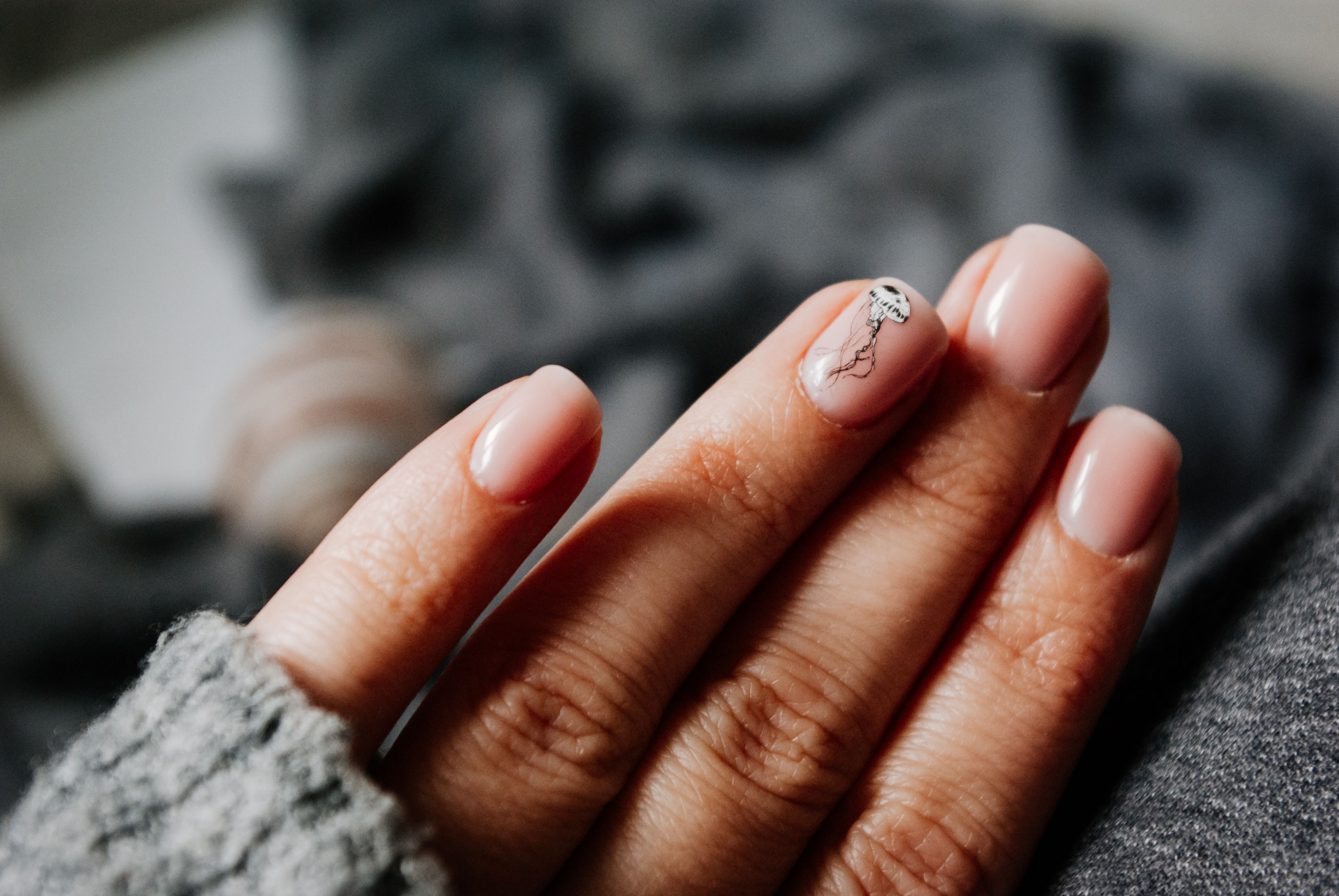 Nail technician applying gel polish